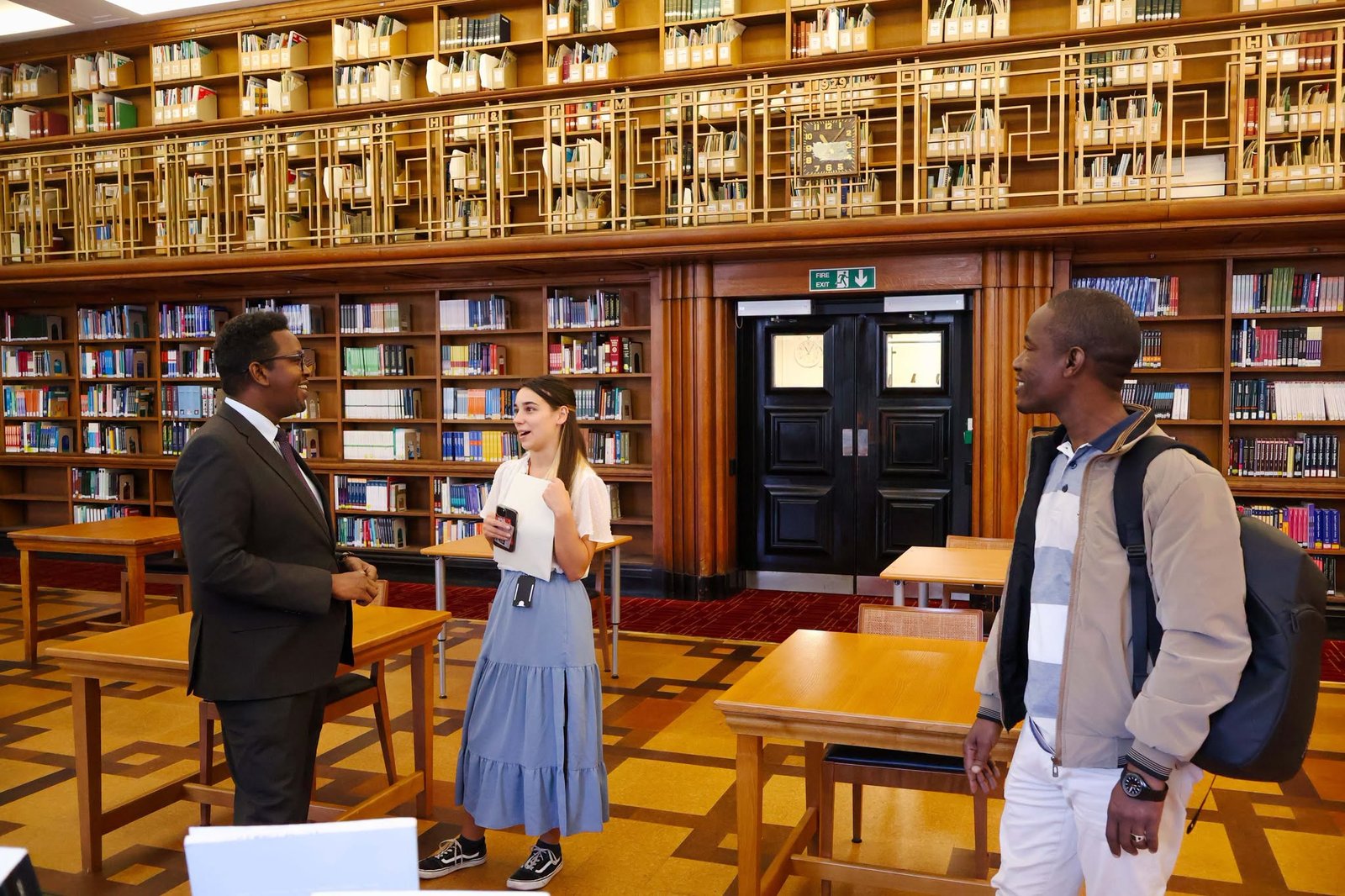 International academic representatives meeting in a university library.